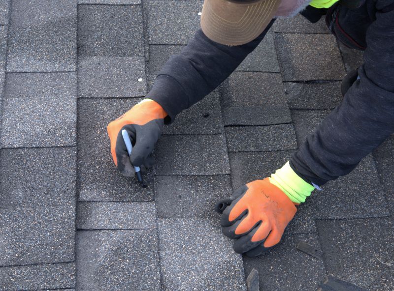 Asphalt shingle roof repair in progress
